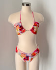 Floral bikini set on a mannequin against a plain background