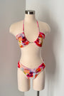 Floral bikini set on a mannequin against a plain background